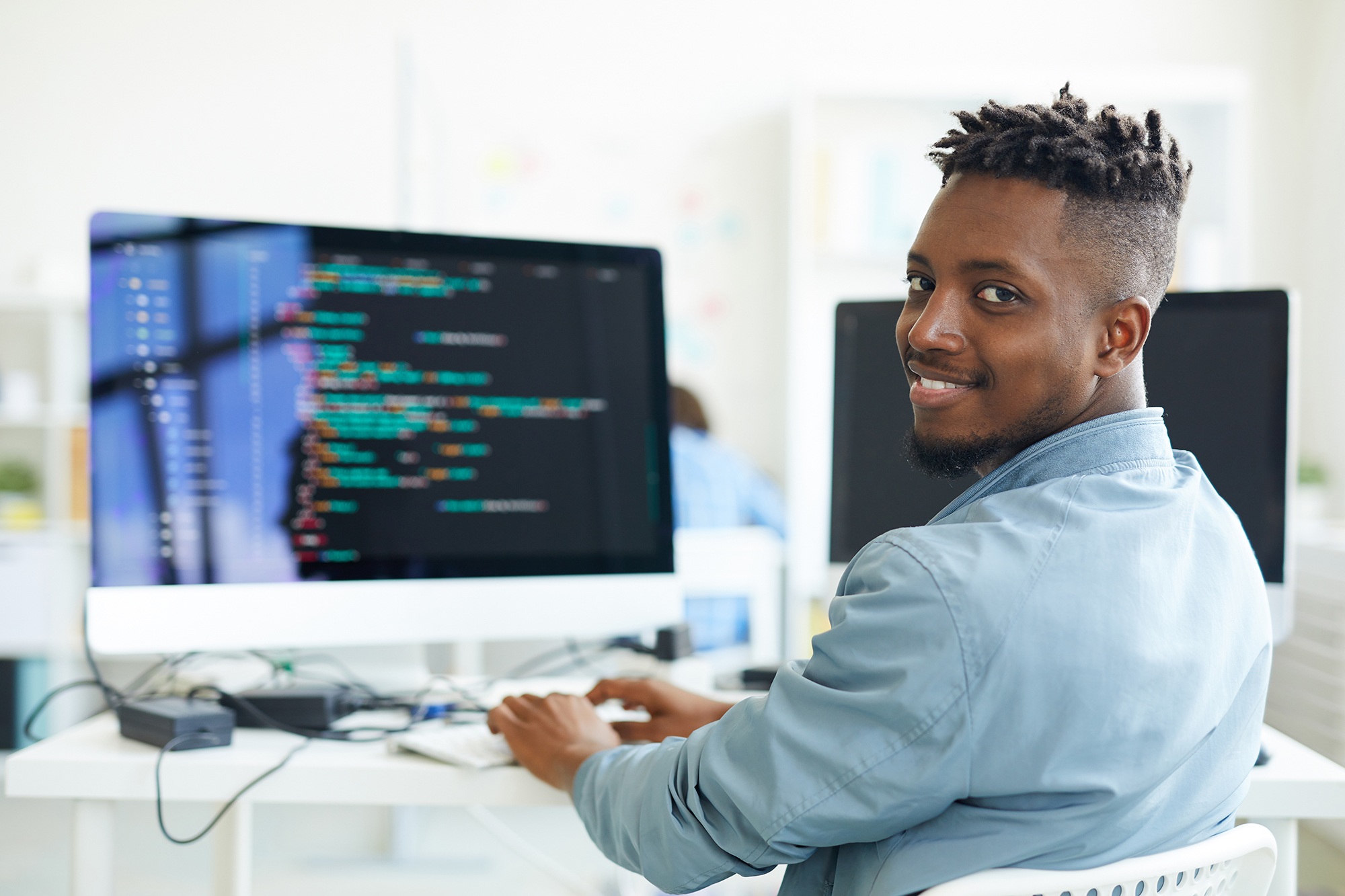 Happy,Guy,Looking,At,You,While,Sitting,By,Workplace,And