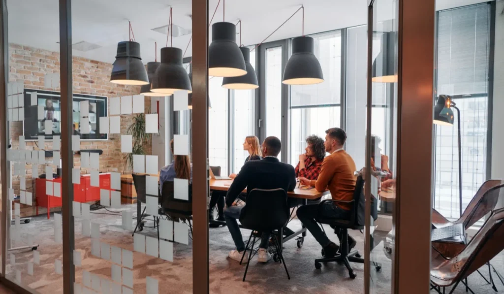 In a sleek glass office space, a team of business professionals